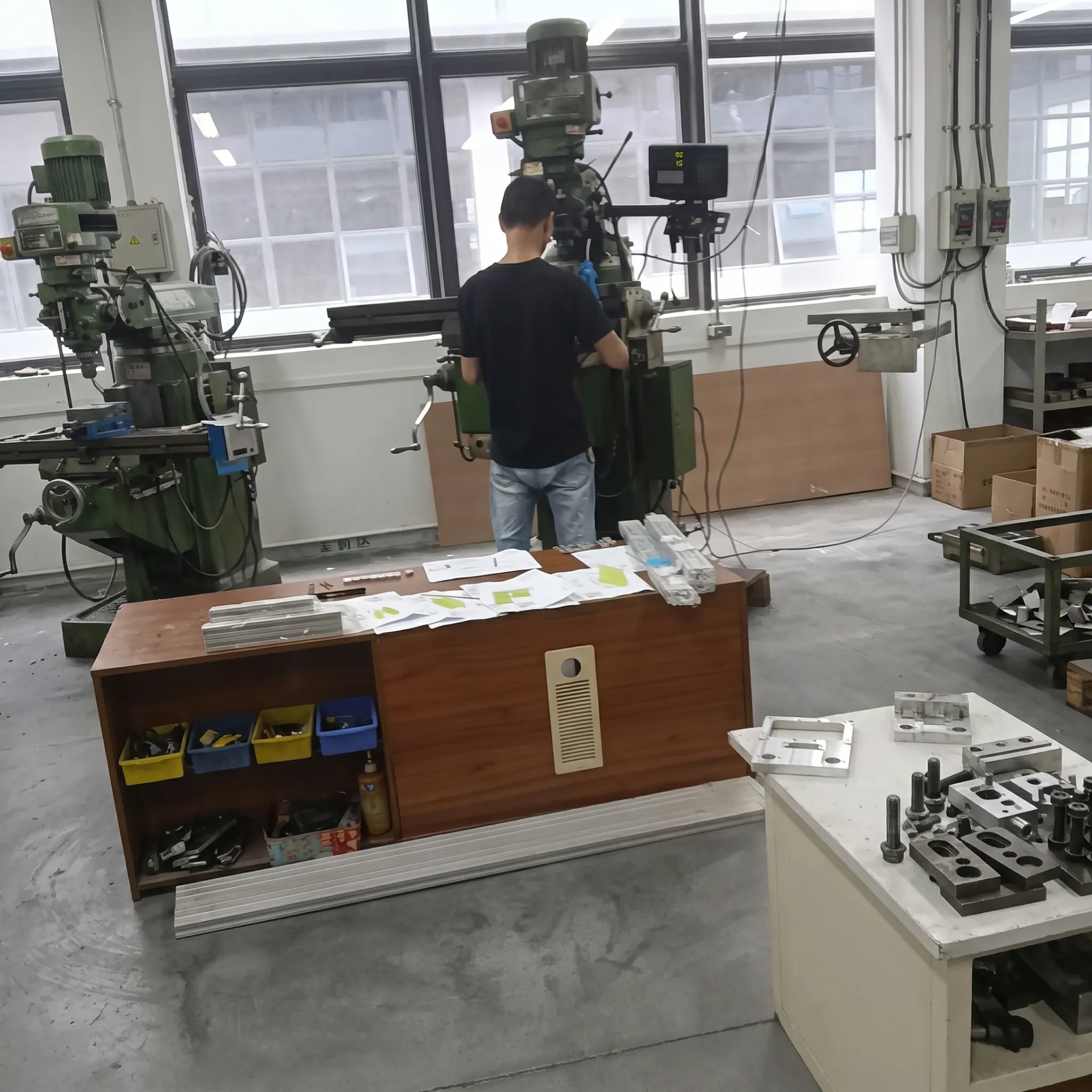 Mechanical engineer reviewing technical drawings at a workstation